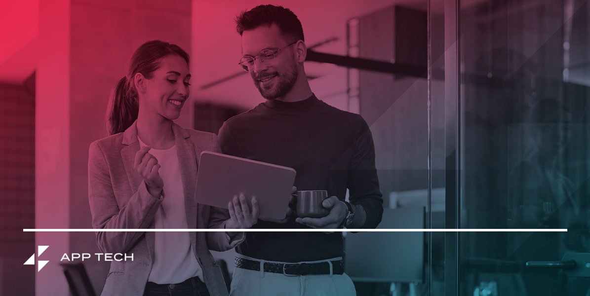 a man and a woman are looking at a laptop computer