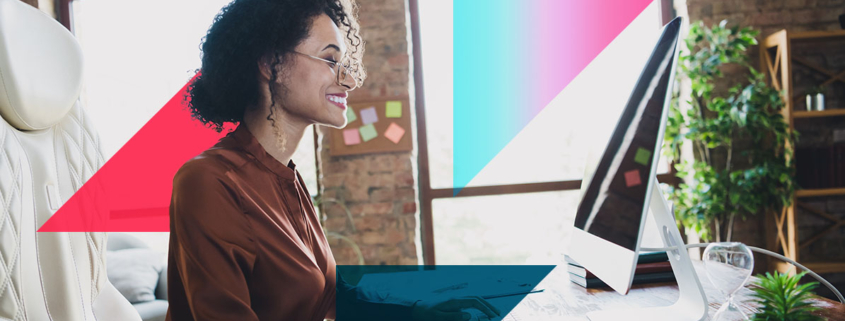a woman is sitting at a desk in front of a computer